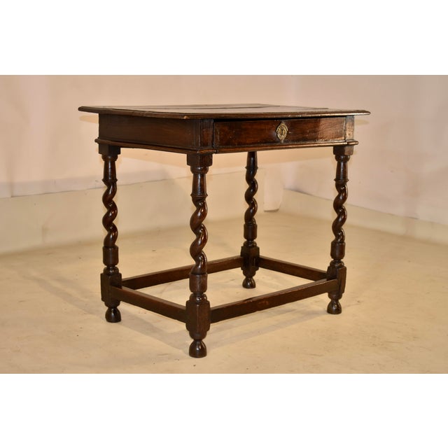 PERIOD 17th century Charles II oak side table from England. The top is made from three planks and has a beveled edge and...