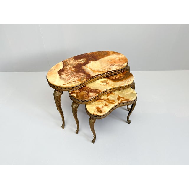 Very elegant vintage nesting stacking tables with brass ornate legs and onyx top. Made in Italy somewhere in the 50s-70s.