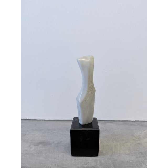 Brazilian modern white Carrara marble sculpture on black granite base by Fatima Fontes, circa 1990s.