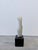 Brazilian modern white Carrara marble sculpture on black granite base by Fatima Fontes, circa 1990s.