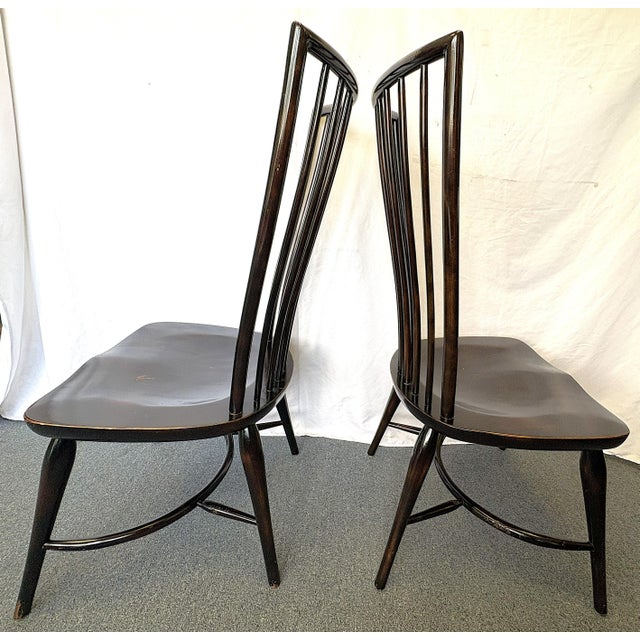 Striking pair of Windsor chairs from the late 20th century. These chairs are made of solid wood in a dark brown ebony...