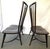 Striking pair of Windsor chairs from the late 20th century. These chairs are made of solid wood in a dark brown ebony...