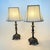 Mid century gilt footed baroque style table lamps. Rectangular cream color shades are included. Lamp mrasured 7.5” square,...
