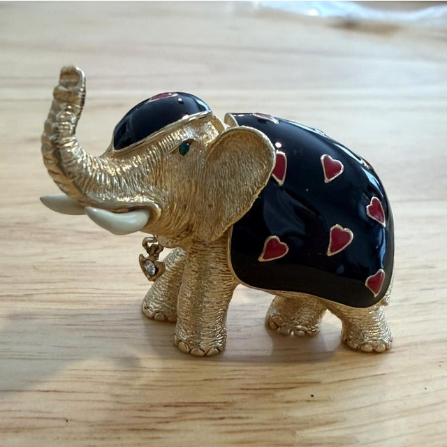 Ciner Elephant Brooh. Gold Tone elephant draped with a black enameled blanket dotted with red enameled hearts. The eye is...