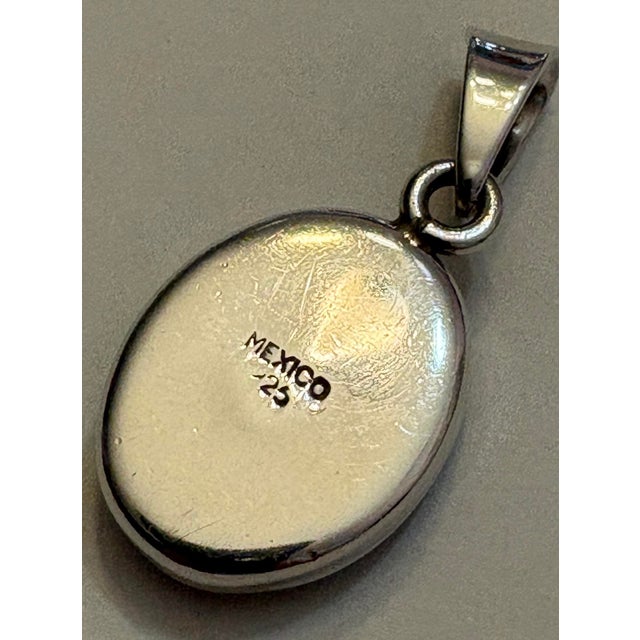 Multicolor inlay Sterling silver pendant is stamped Mexico .925 and measures approximately one and a half inches long....