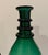 Antique green glass decanter, ovoid body with three ringed neck ending in a flared lip. Partially polished pontil on the...