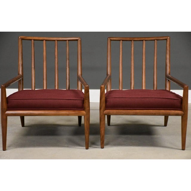 A pair of mid century modern solid walnut lounge chairs with wine maroon red tweed new upholstery designed by T.H....