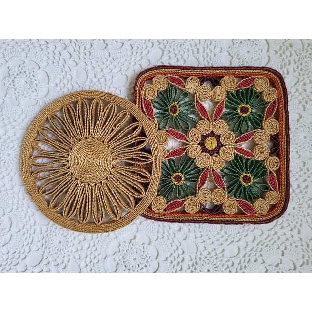 A pair of boho trivets, likely from the 1970s. One is round and measures 7” diameter x ½”. The square one is 8” sq x ½”....