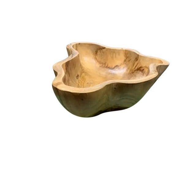 This teak live edge bowl is a unique piece showcasing the natural beauty of teak wood. Crafted by skilled artisans, its...
