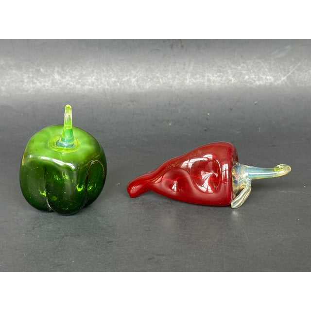 These hand blown glass peppers would make charming decor accents displayed on a shelf in a chef's kitchen. The set of two...