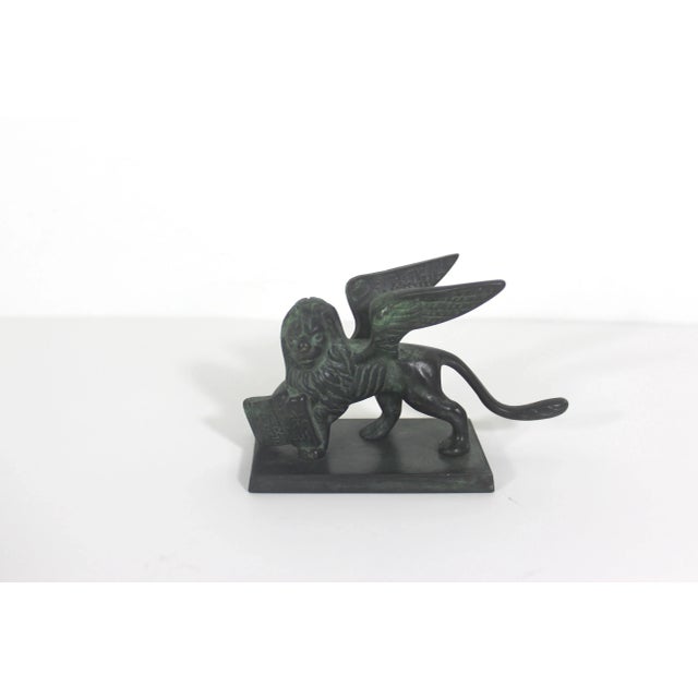 This is a small but heavy bronze sculpture of the Lion of San Marco Venice Italy. It has a lovely verdigris patina. The...