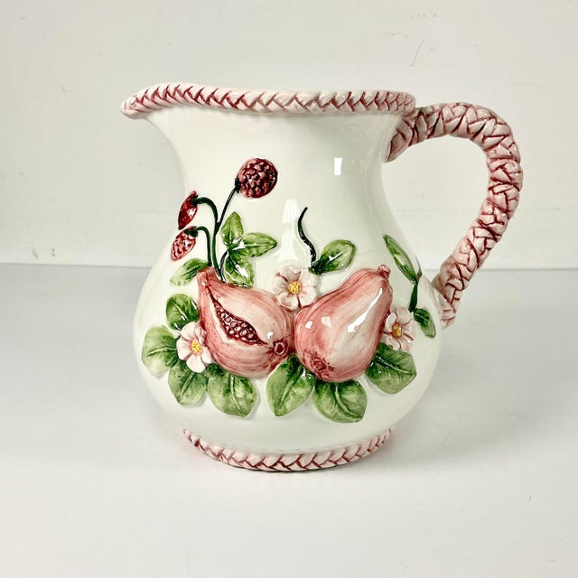 This ceramic English Garden Pitcher is beautiful. It features raise-relief Pomegranates, red raspberries and leaf foliage...