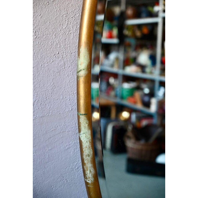 This beautiful oval beveled mirror has a wooden frame accented with gold. It is large, pleasantly proportioned, and has a...