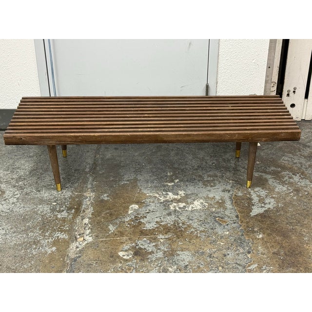 Design Plus Gallery presents a Vintage Mid-Century Modern Slatted Walnut Bench / Coffee Table. A long rectangular profile...