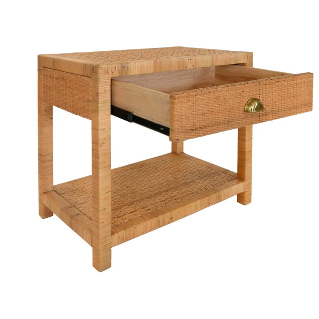 One drawer end table in rattan with brushed brass cup pull and soft close glides. *Rattan has natural variations and may...