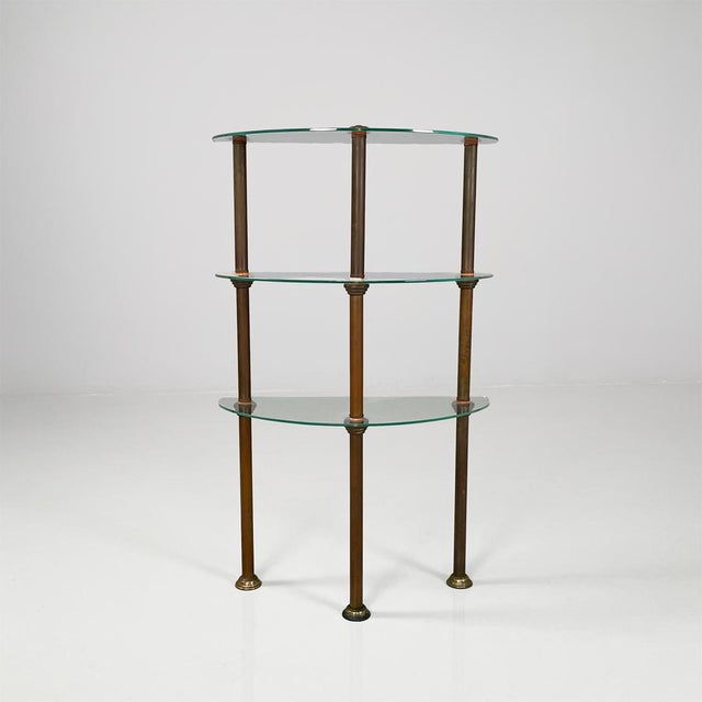 Italian three-shelf console table in metal and glass, 1920s Three-tier glass console. The structure is composed of three...