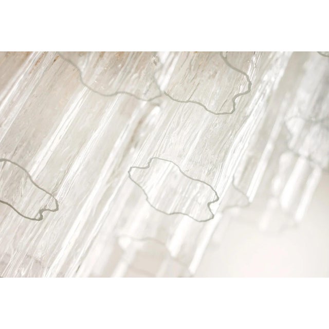 A sophisticated bespoke Dallas chandelier by Abrissi, custom-ordered in 2017. The dramatic tiered silhouette is formed by...