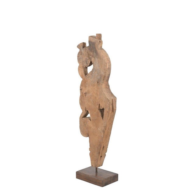 This Antique Indian Carved Teakwood Corbel on a Stand is hand-carved from solid teakwood, featuring a graceful bird form...