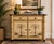 A sophisticated Hollywood Regency cabinet featuring a hand-painted tropical finish, carved bamboo-inspired corner pillars,...