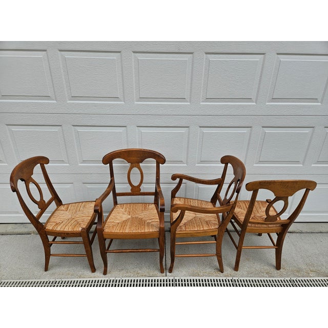 A classic set of four Pottery Barn Napoleon rush seat dining chairs. This set has two arm chairs and two side chairs. The...
