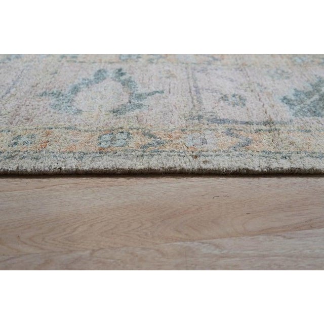 This ivory beige cream white rug is constructed from silk using a hand knotted pile weave. Originating from India, this...
