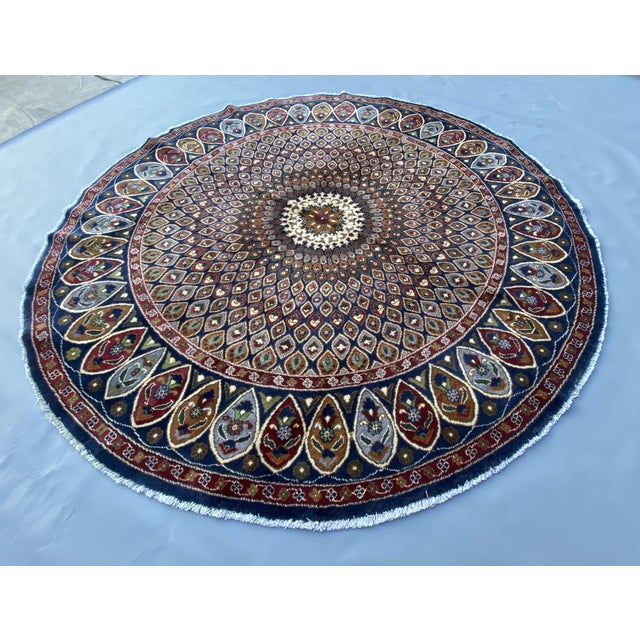 This handmade round rug features a classic Persian Tabriz medallion design, woven in Afghanistan using traditional...