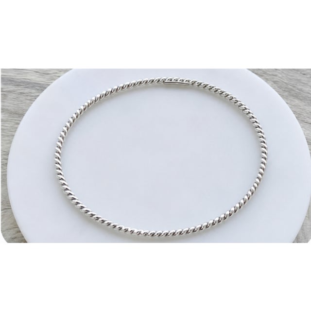 A timeless Tiffany & Co. sterling silver twisted rope cable bangle, discontinued and in brand new, never-worn condition -...
