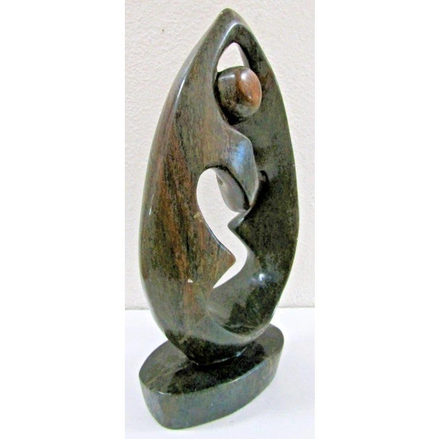 Large Hand-carved Shona Serpentine Stone Couple Sculpture Measures 8 1/2" wide, 4 1/2" deep and 15 1/2" tall. This is an...