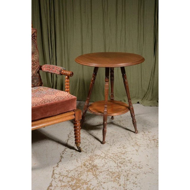A generously sized and versatile Aesthetic Movement walnut occasional table, with an attractive one piece top and an...