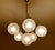 Vintage 1970s pendant lamp featuring a cascade arrangement of four opaline globe glass shades on a chrome and brass...
