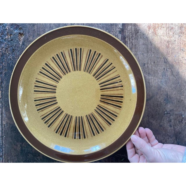 Fun and groovy 1970s stoneware platter, round in shape. It is presented on a golden mustard glaze with teeny speckles...