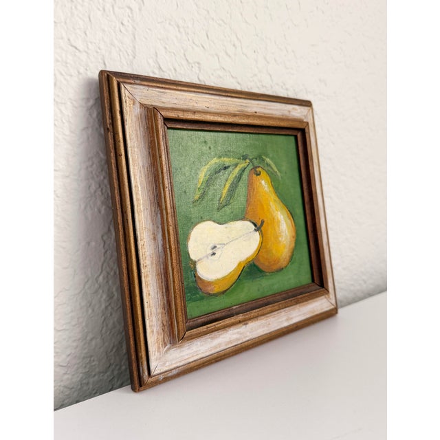 Mid 20th century miniature, original painting on board depicting yellow pears with a vibrant green background. The wood...