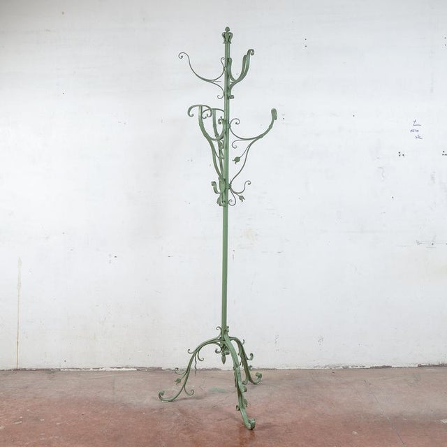 This striking metal coat rack, dating from the second half of the 20th century, is a modern antique piece that combines...