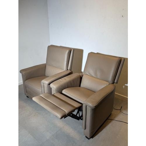 Comfort meets clean design with this set of 2 electric relax armchairs upholstered in taupe leather. Both chairs are in...