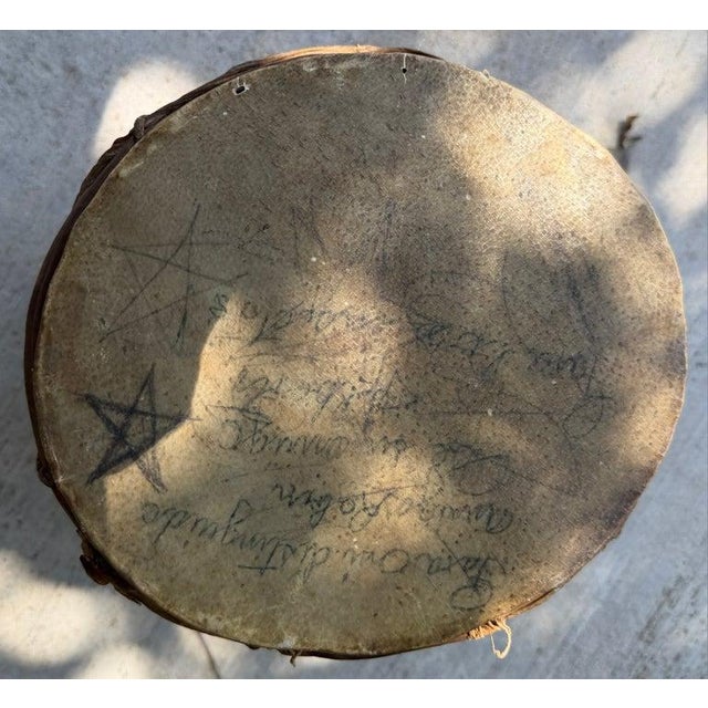 Early 19thc Pueblo Indian drum with writing on the drum.This is in good condition and is uneven on the top of the drum...