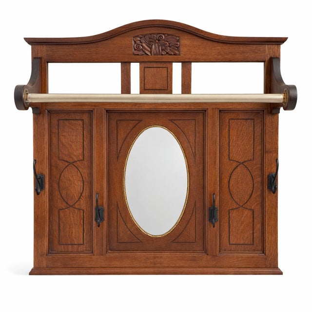 Antique oak hall / entryway mirror with hooks and a hanging bar. Simple but with some decorative elements that make it...