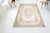 This is a vintage Turkish Oushak rug from the Mid 20th Century. The piece was hand-knotted.