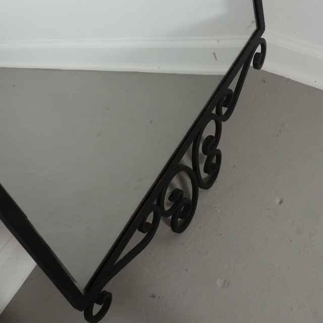 Wrought iron wall mirror in the style of Salterini. Wonderful vintage condition. 24”W x 1”D x 47”H