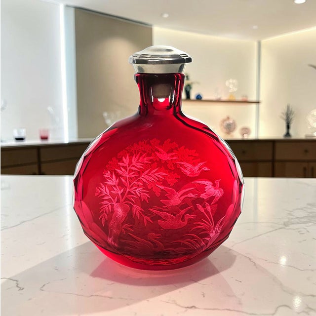 A Saint Louis crystal flask executed in deeply saturated ruby overlay, cut to clear with a finely detailed hunting scene...