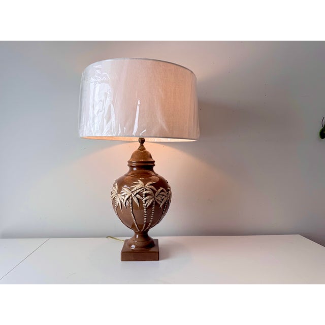 Vintage ceramic palm tree and bamboo relief designed table lamp paired with a large linen barrel shade.