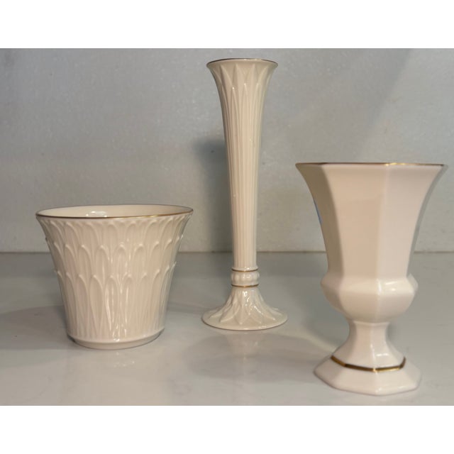 Add some Hollywood Regency glamour to your home with this curated set of three ivory and gold vases from Lenox. The set of...