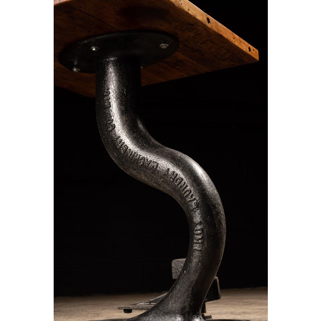 Vintage pub table constructed of cast iron with butcher block surface. 27"W x 28"D x 33.5"H. This vintage cafe table...