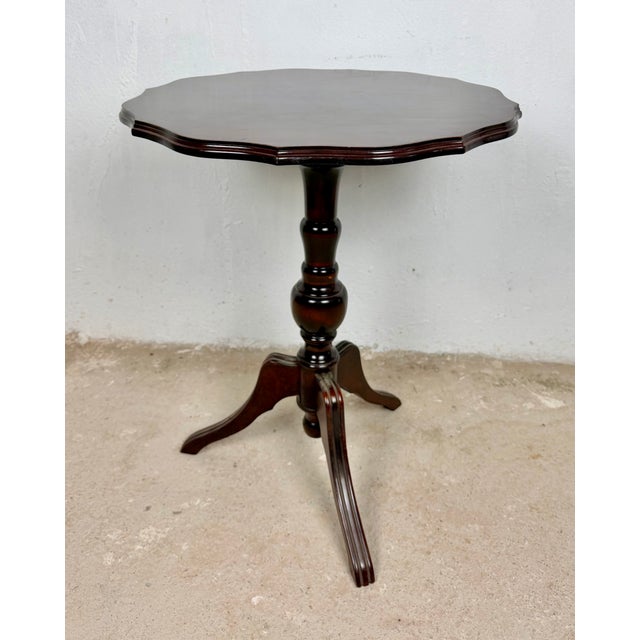 Elegant English side table, featuring a shaped octagonal top raised on a finely turned pedestal with a classic tripod...