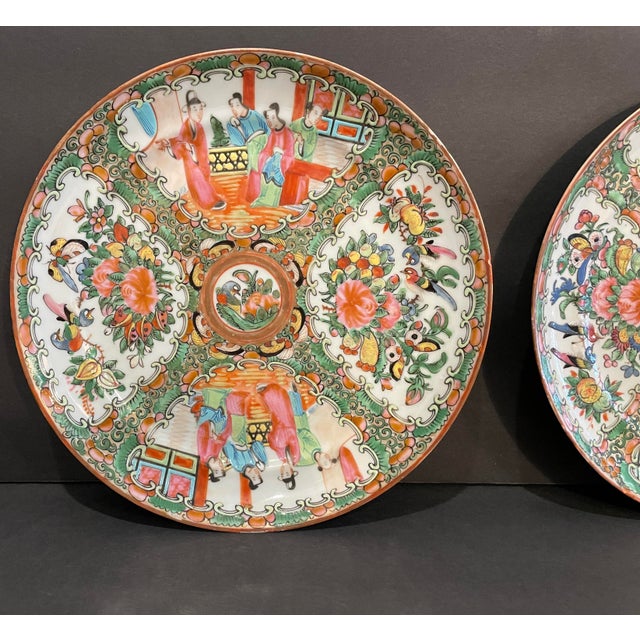 A pair of antique Rose Medallion pattern Chinese plates. Famille rose color family enamel over white porcelain. Each...