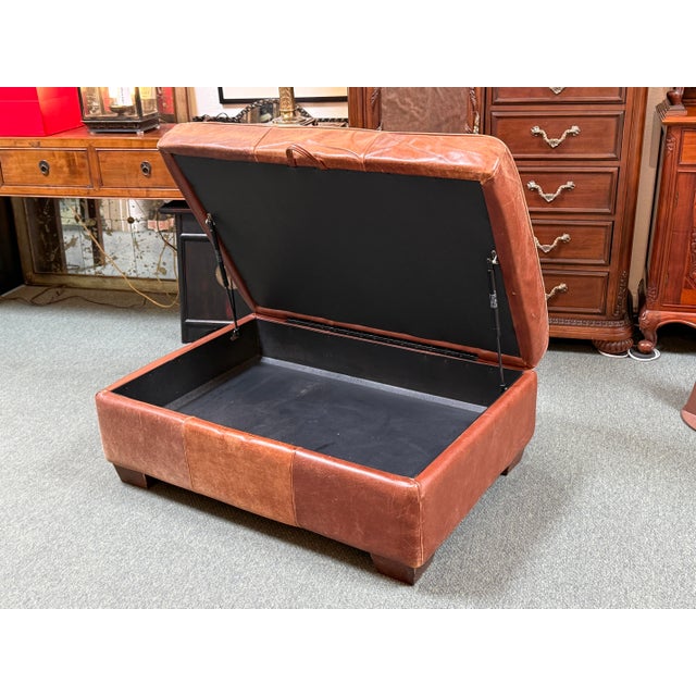 Design Plus Gallery presents a Cognac Leather Distressed Ottoman with Storage. The pure hide piece is an elongated...