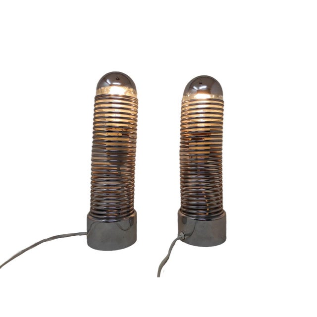 Wonderful pair of space-age lamps by Harvey Guzzini, made in Italy, from the 1970s. The frame is made of a flexible,...