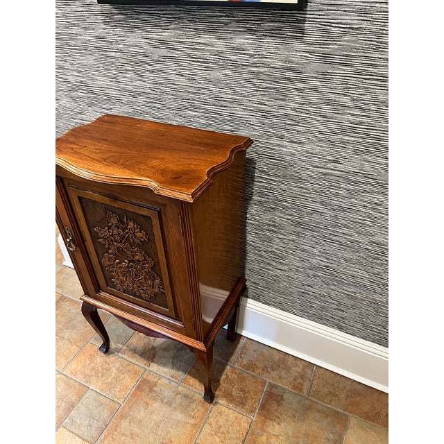 This is a beautiful antique English cabinet with gorgeous floral carvings on the door. It has inset hinges and an...