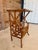 A charming vintage faux bamboo side table featuring an architectural lattice-form base and a natural grasscloth inset top....