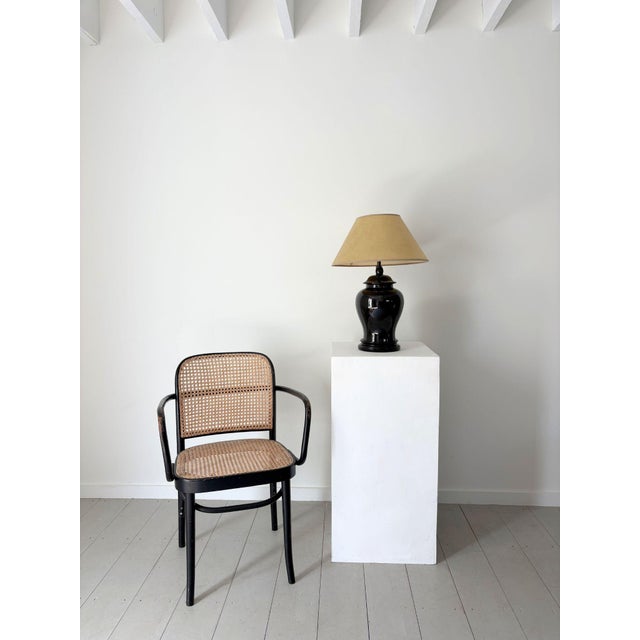 A late 20th century ceramic table lamp in a black gloss glaze. The high shine finish bounces light and emphasises the...