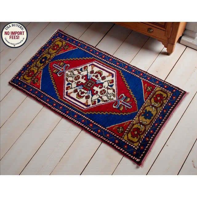 This vibrant Tashpinar mat showcases a bold geometric medallion that anchors any small space with authentic tribal energy....
